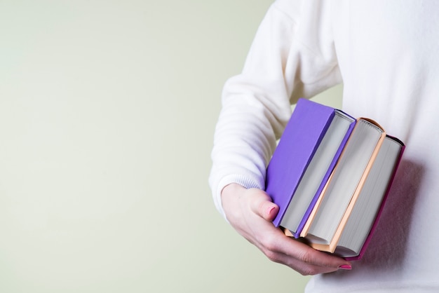 Free photo hand with three books close-up