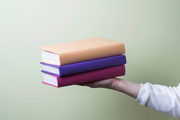 Hand with three books