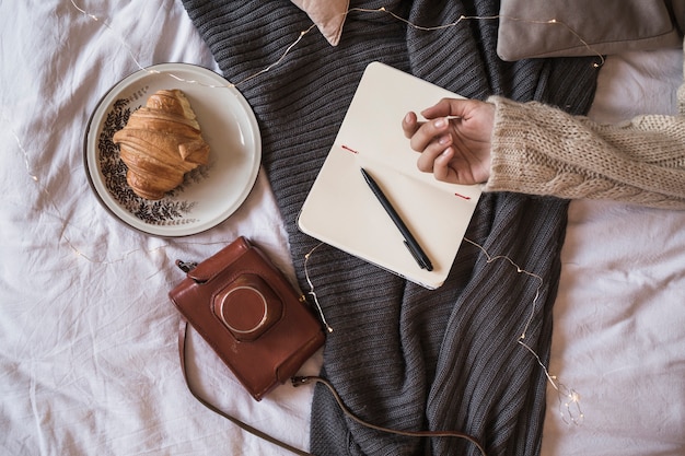 Hand of woman on opened notebook