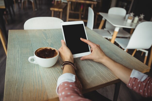 Hand of woman using digital tablet