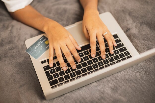 Hand writing on laptop on grey background