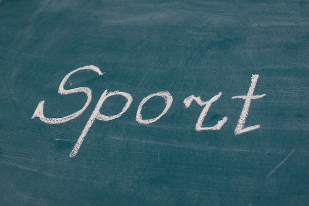 Hand written sport word on blackboard