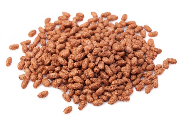 Handful of chocolate cereals over white background