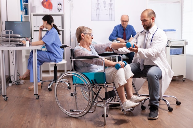 Handicapped patient getting help from physical therapist