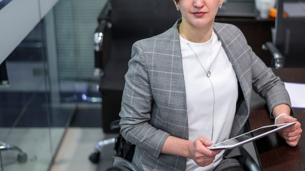 Free photo handicapped young woman in office high view