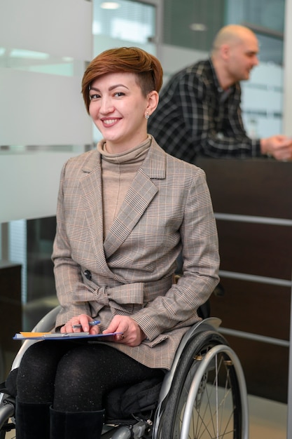 Handicapped young woman in office smiling