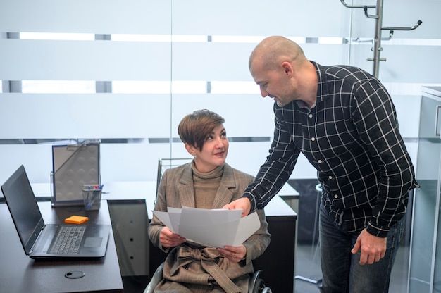 Handicapped young woman in office with a man