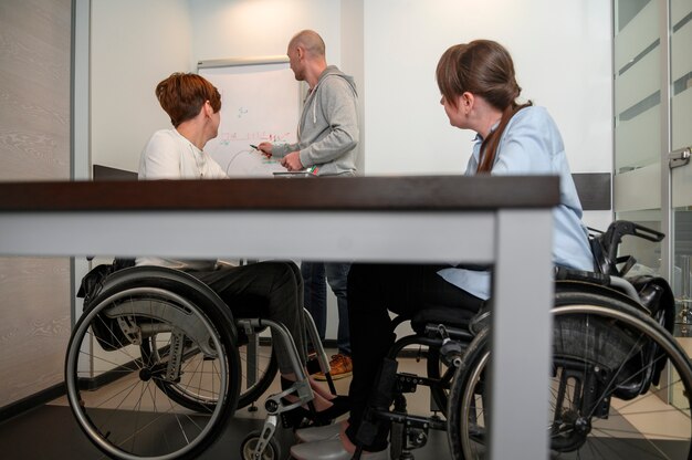 Handicapped young woman in office with team