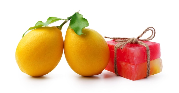 Handmade citrus soap and fresh fruit on white background