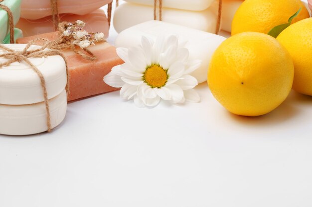 Handmade citrus soap and fresh fruit on white background