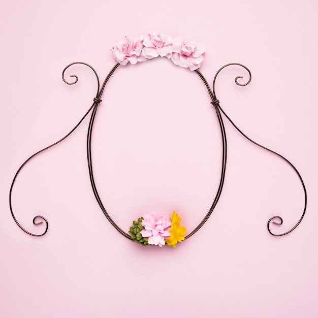 Handmade flower decorative empty frame on pink backdrop