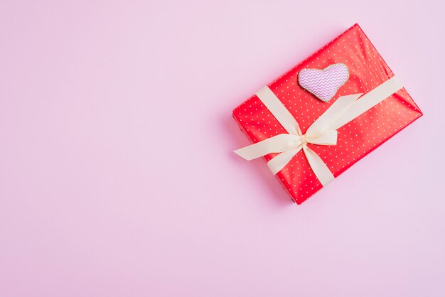 Handmade heart lying on adorable present