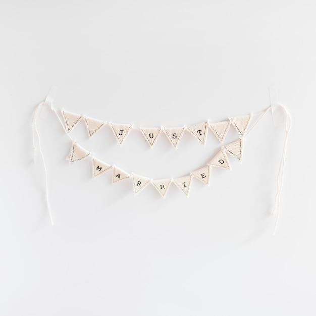 Free photo handmade just married bunting on white backdrop