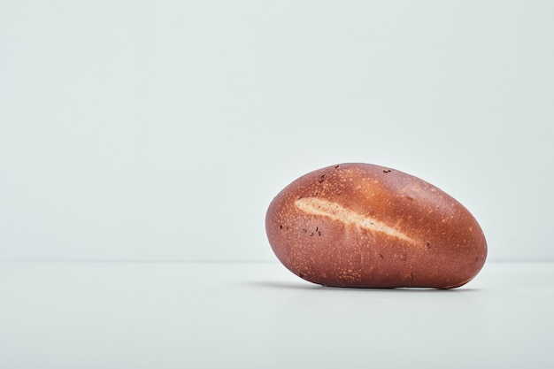 Handmade oval bread on grey table.