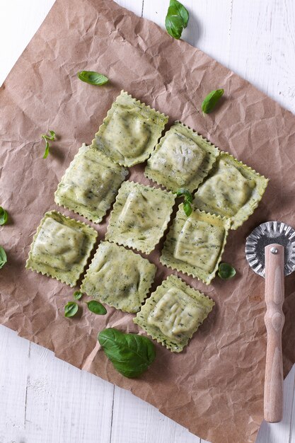 Handmade raviolis with basil leaves