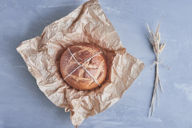 Handmade round bread on a piece of paper.