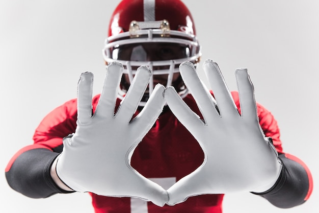 The hands of american football player on white