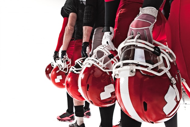 The hands of american football players with helmets on white space