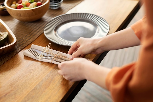 Hands arranging cutlery close up