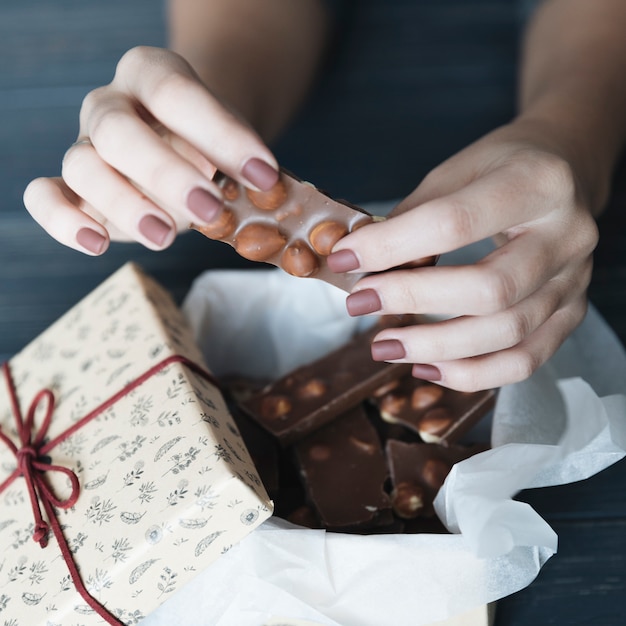 Free photo hands breaking chocolate