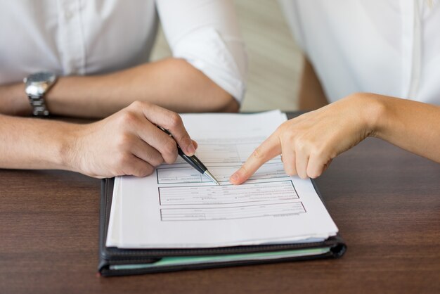 Hands of businessman and businesswoman discussing agreement.