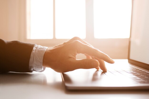 Hands of a businessman using laptop on the internet