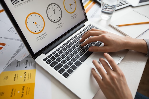 Free photo hands of businesswoman using laptop in office