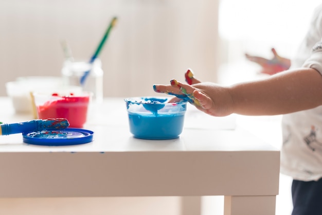 Hands of child with paint