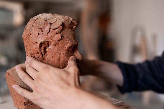 Hands clay sculpting side view