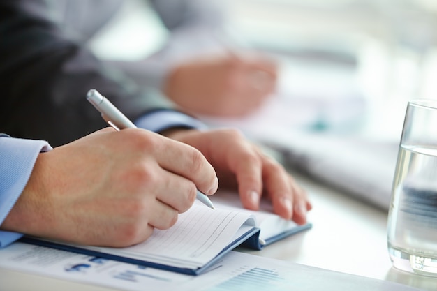 Hands close-up of executive writing a letter