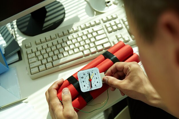 Hands close-up of man preparing a bomb