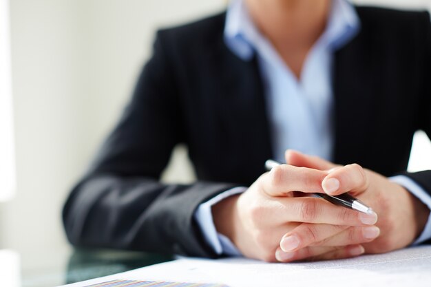 Hands close-up of woman holding a pen