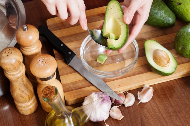 Mani che cucinano con avocado