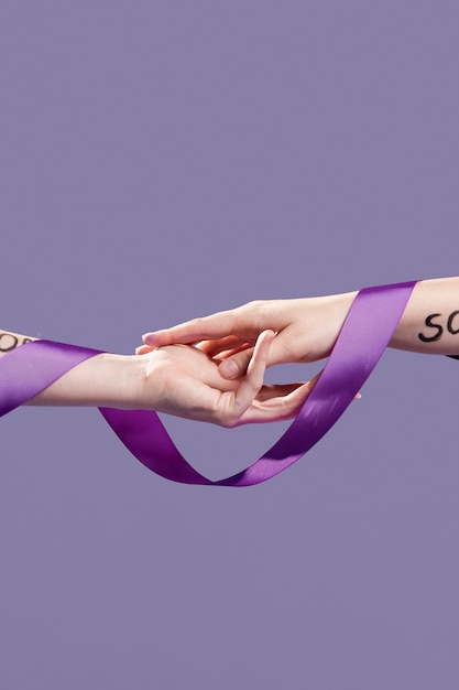 Hands covered with ribbon and empowering words