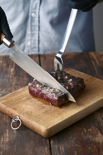 Нарезать руками стейк из китового мяса средней прожарки