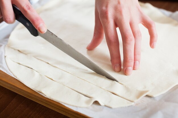 hands cutting store-bought dough