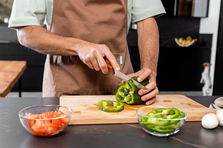 Free Photo hands cutting vegetable close up