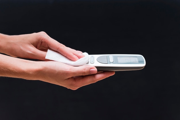 Hands disinfecting telephone