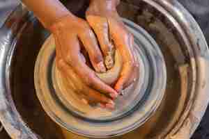 Free photo hands doing pottery close up