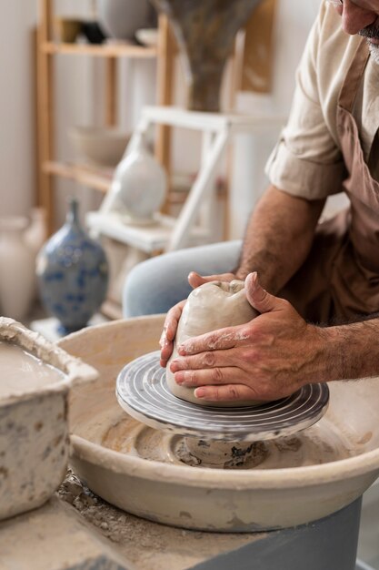 Hands doing pottery close up