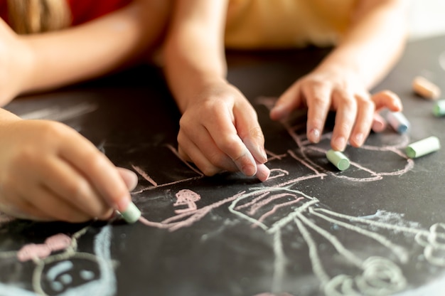 Hands drawing with chalk close up