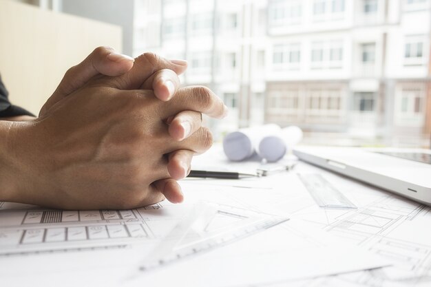 Hands of Engineer working on blueprint,Construction concept. Engineering tools.Vintage tone retro filter effect,soft focus(selective focus)