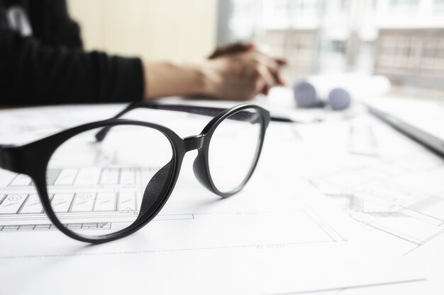 Hands of Engineer working on blueprint,Construction concept. Engineering tools.Vintage tone retro filter effect,soft focus(selective focus)