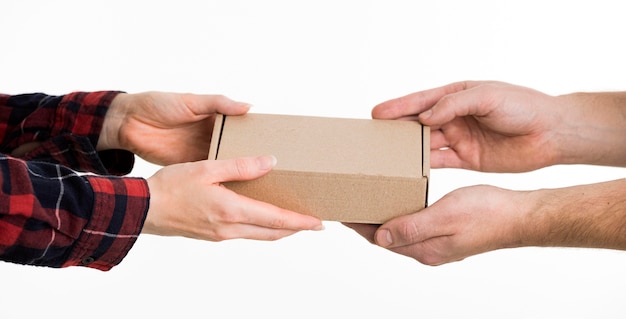 Hands exchanging cardboard box
