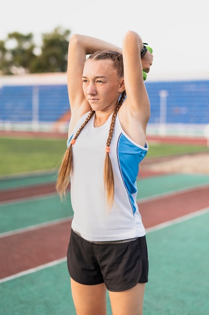 Free photo hands exercise with weights on stadium