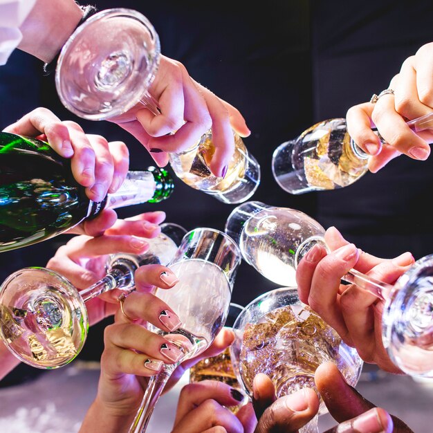 hands of friends with wineglasses
