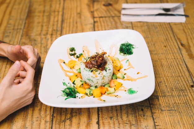 Hands in front of dish