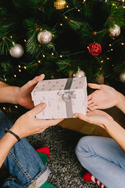 Hands giving present to person