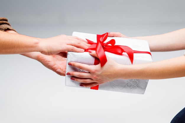 Hands giving and receiving a present