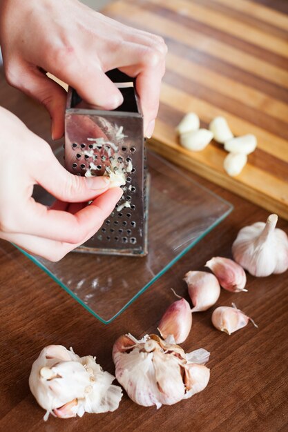 hands  grating garlic